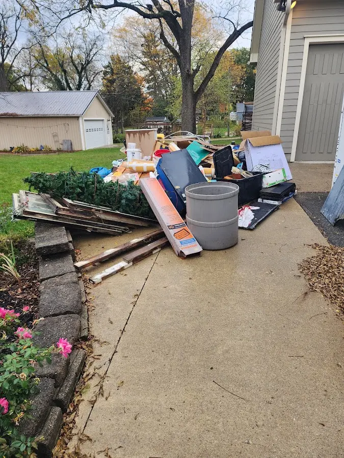 Dumpster being loaded with debris for 12 Yard Dumpster Rental in Levant